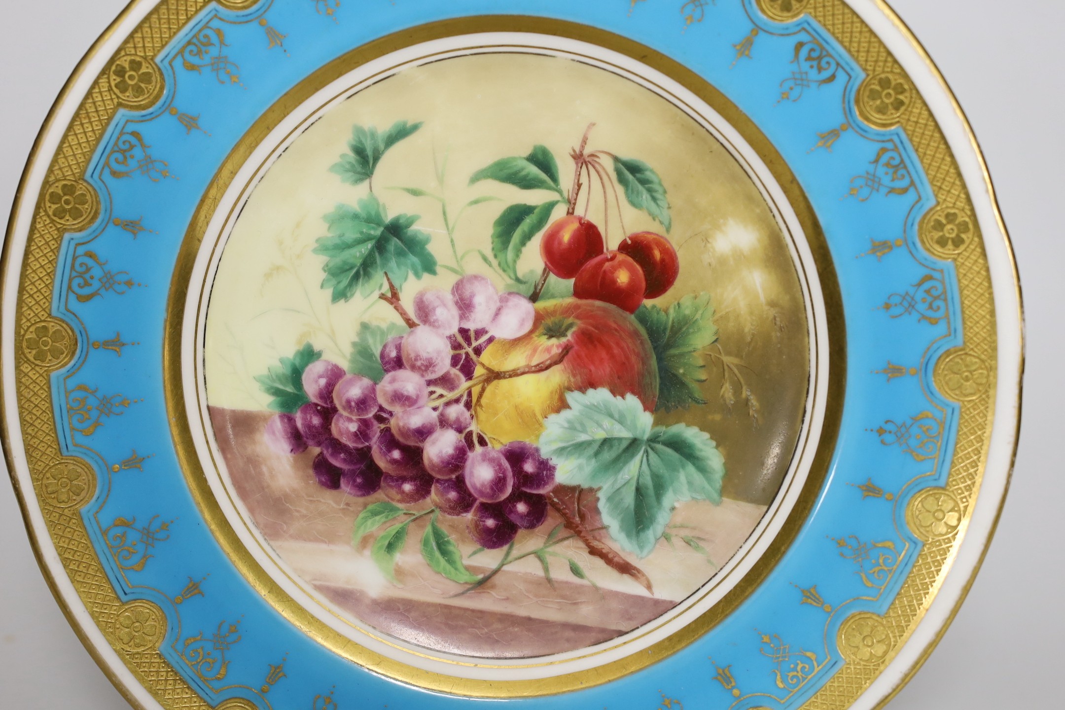 A Minton plate painted with fruit under a turquoise border, 23cm